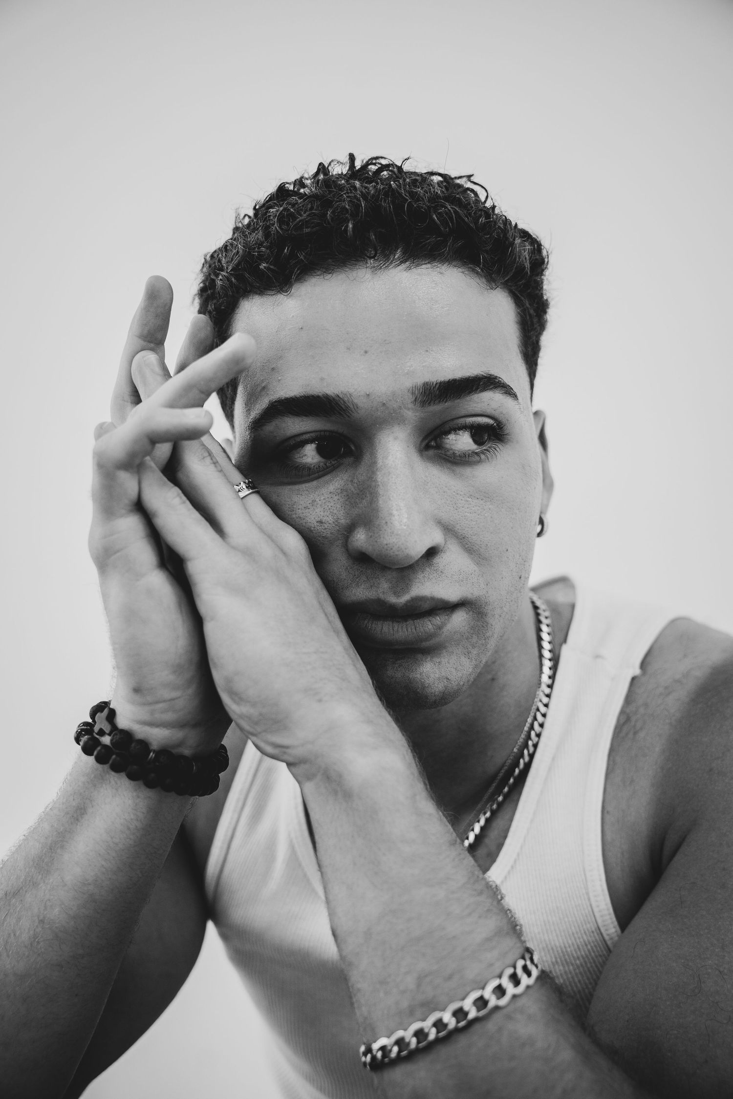 Dynamic black and white portrait sequence capturing movement and interaction between hands and face.