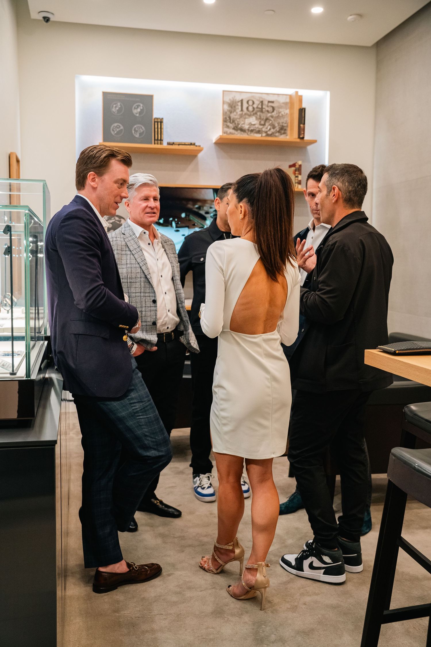Group of people having a business conversation in a modern retail space.