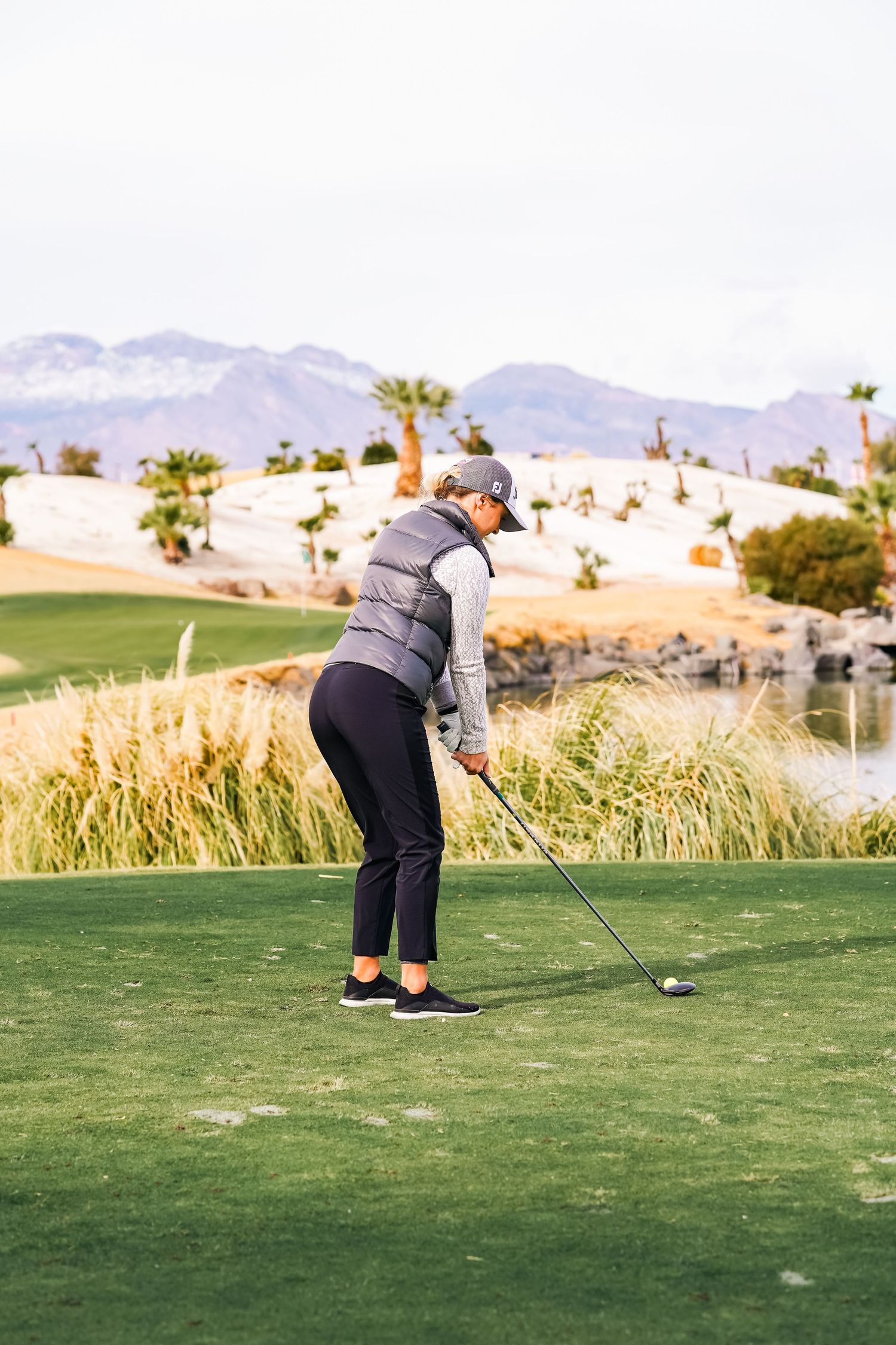 Golfer practicing their swing form on a lush green fairway.