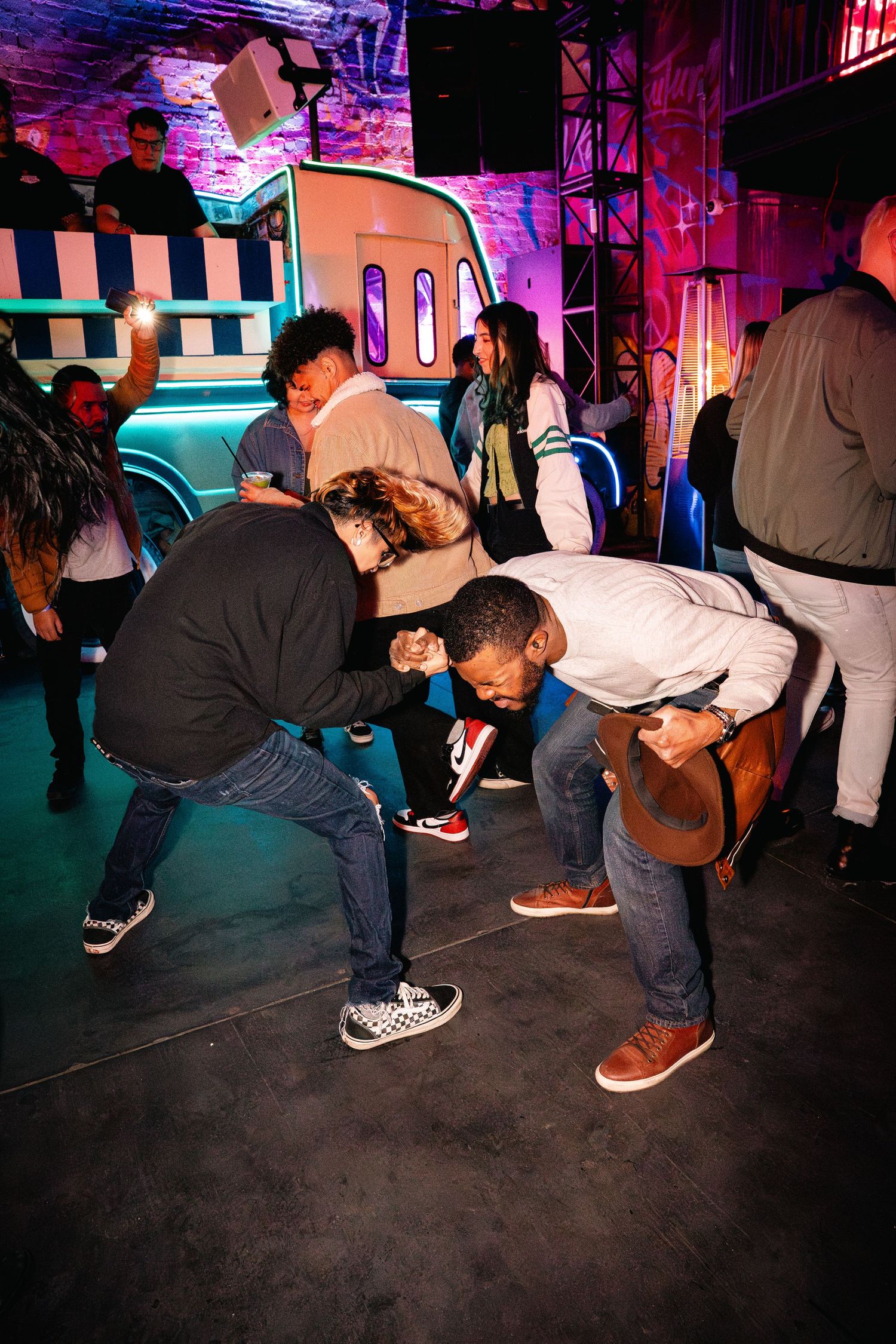 Group of party-goers dancing and having fun at nightclub event.