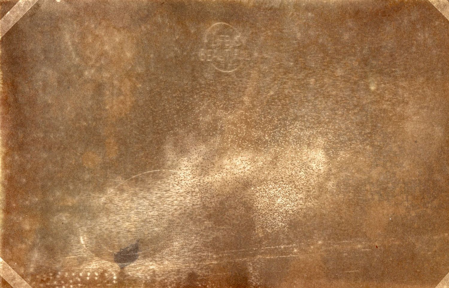 Vintage sepia photograph with aged texture and discoloration.