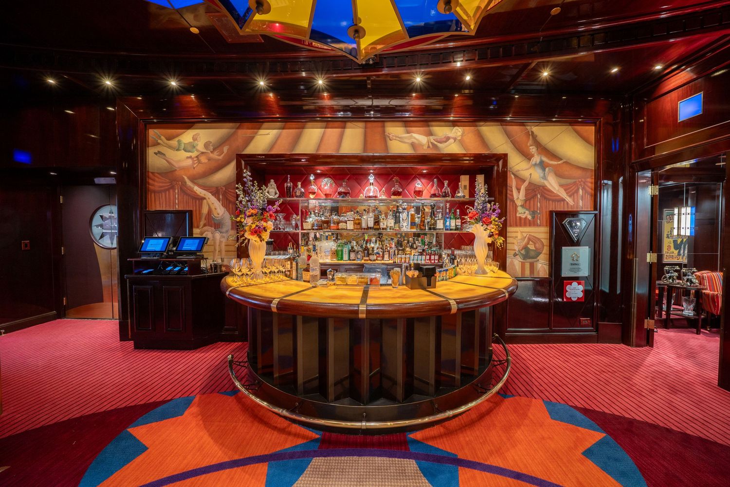 Circular bar with dramatic lighting and blue geometric floor patterns in a casino setting.