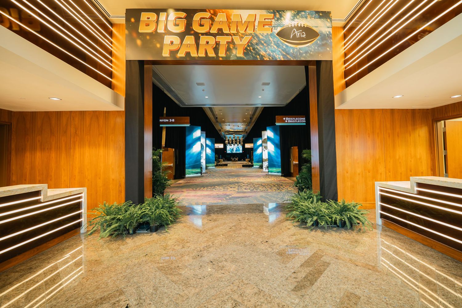 Casino entrance area with illuminated 'Big Game Party' signage and wood-paneled walls.