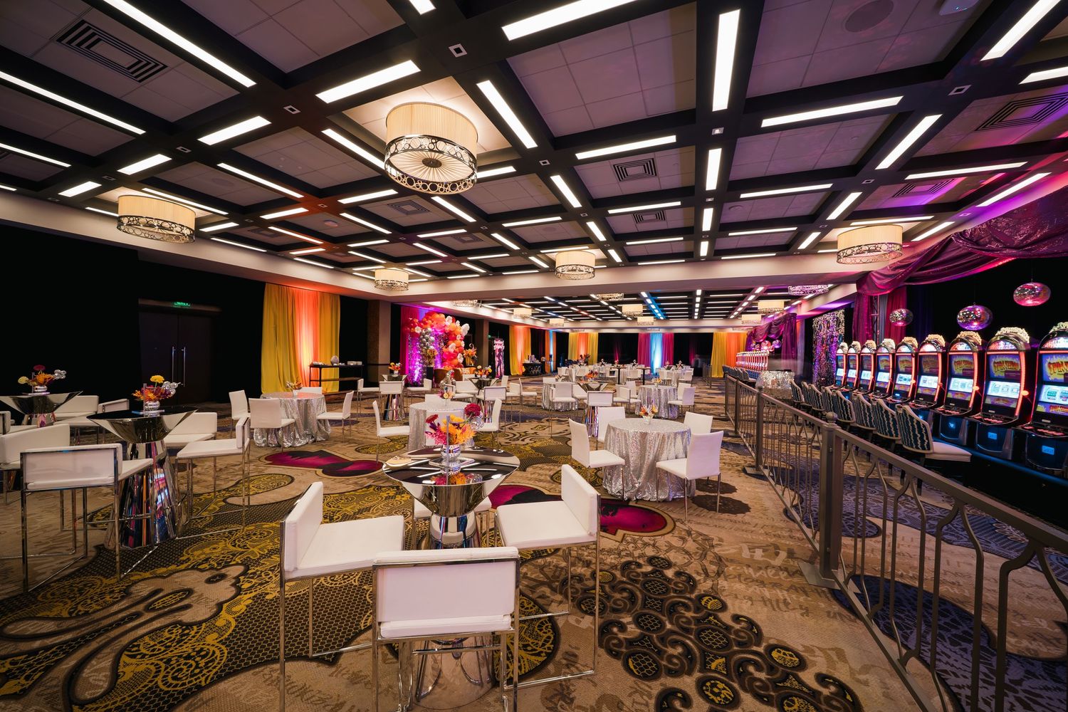 Contemporary casino gaming floor with modern lighting fixtures and geometric ceiling design.