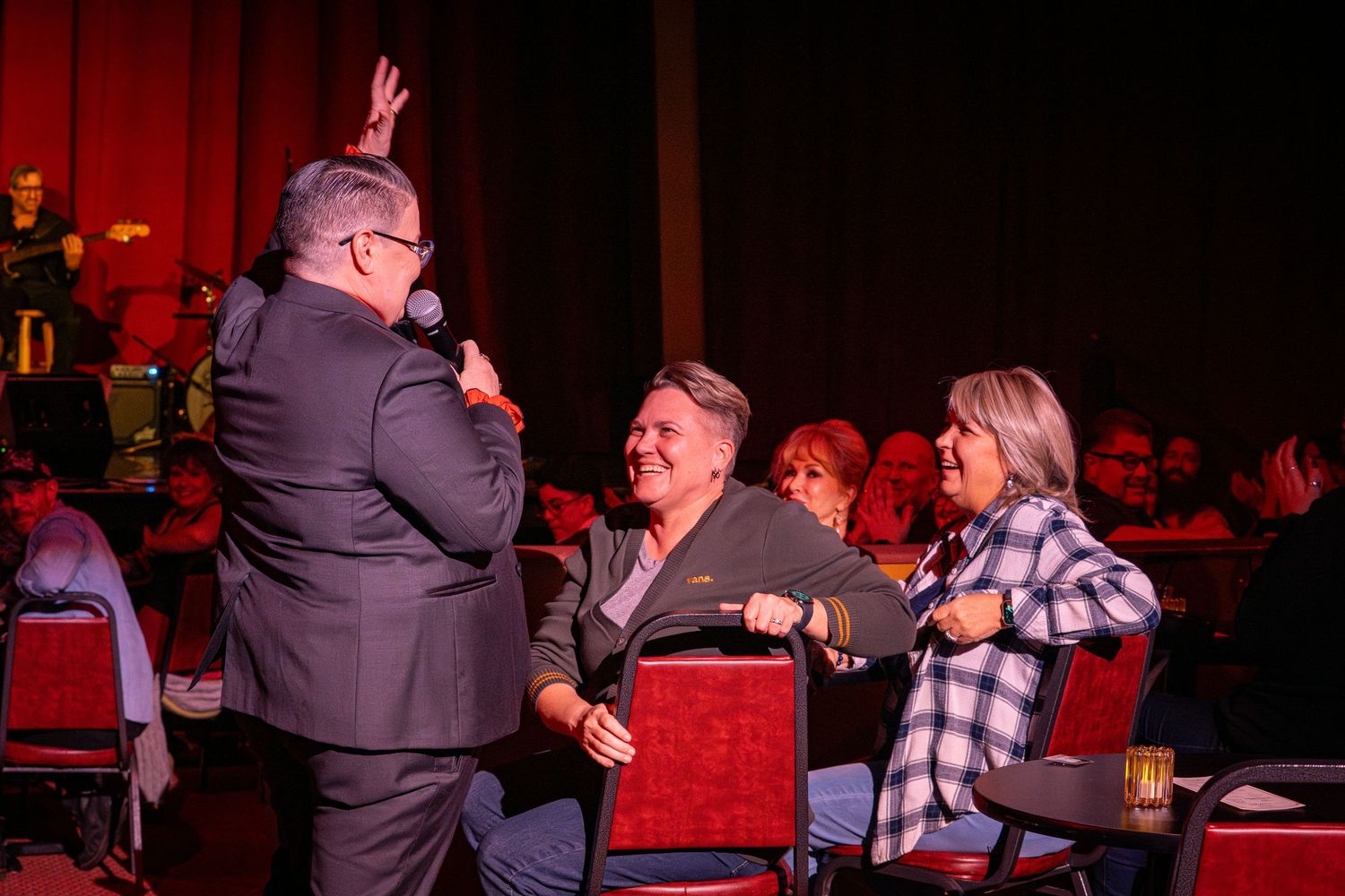 An entertainer interacts with audience members during a live performance.
