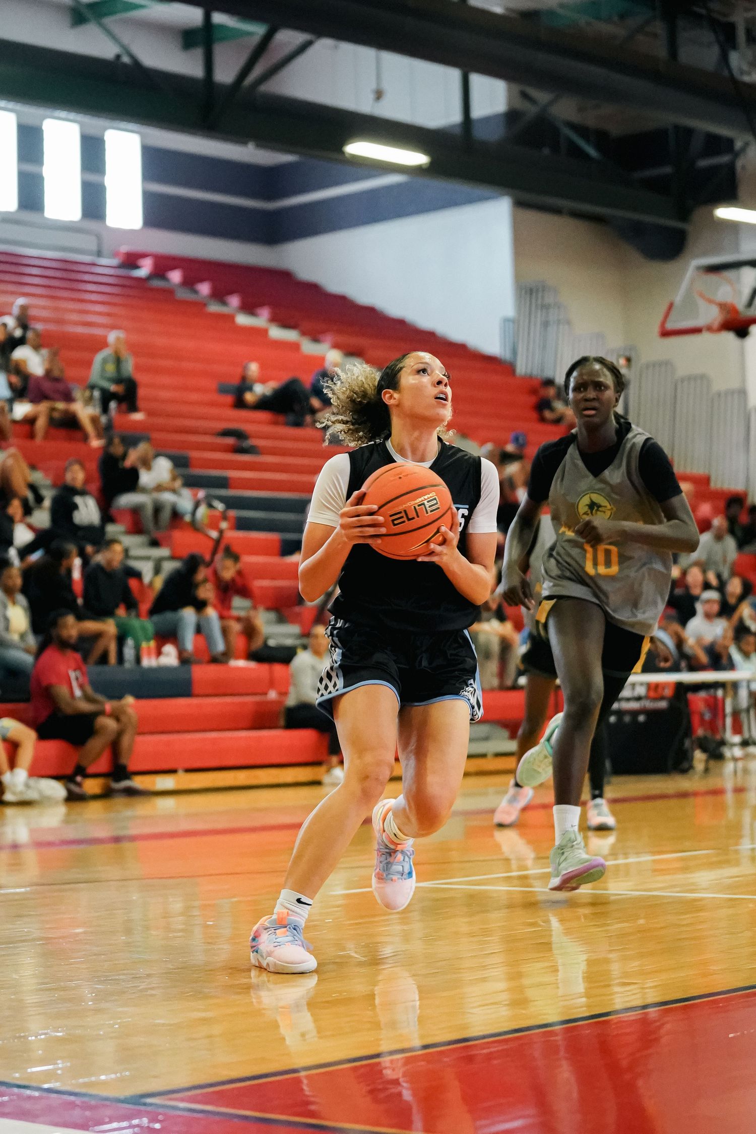 Players in action diving for loose balls during an intense basketball practice.