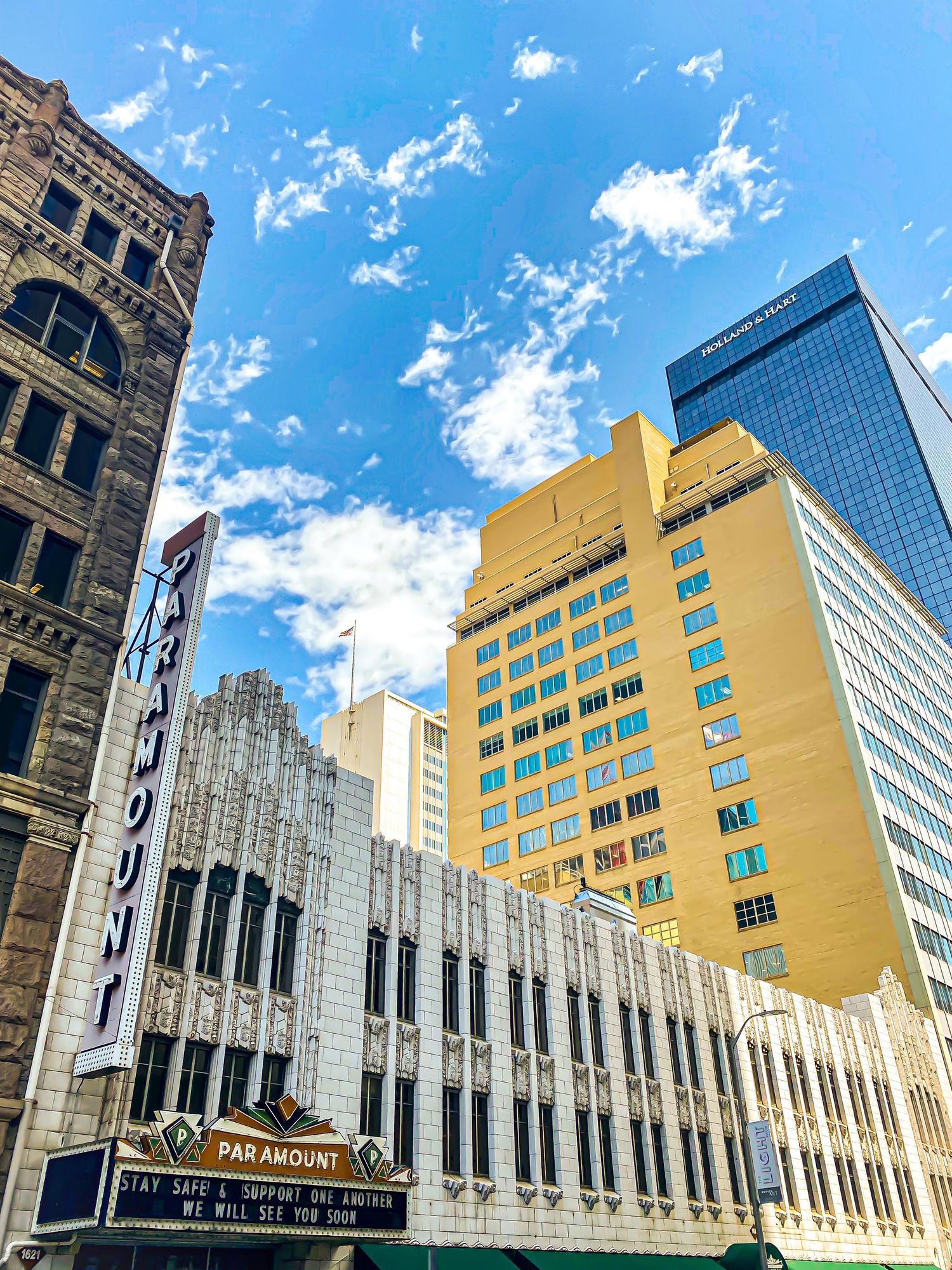 Art deco style Paramount building with gold facade under bright blue sky in urban setting.