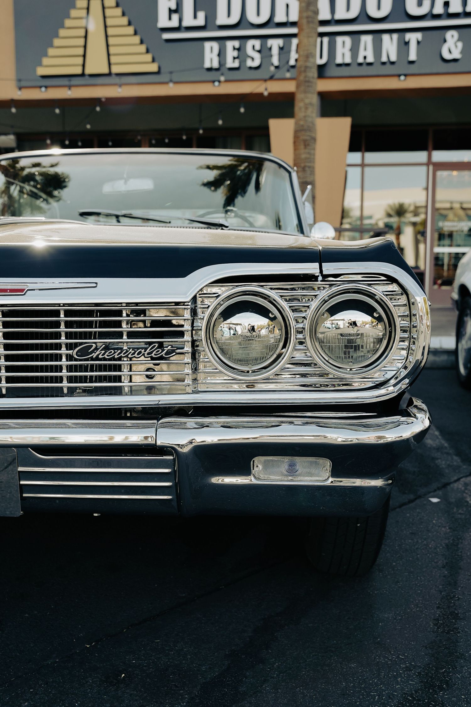Vintage chrome grille details of classic car with El Dorado sign in background.