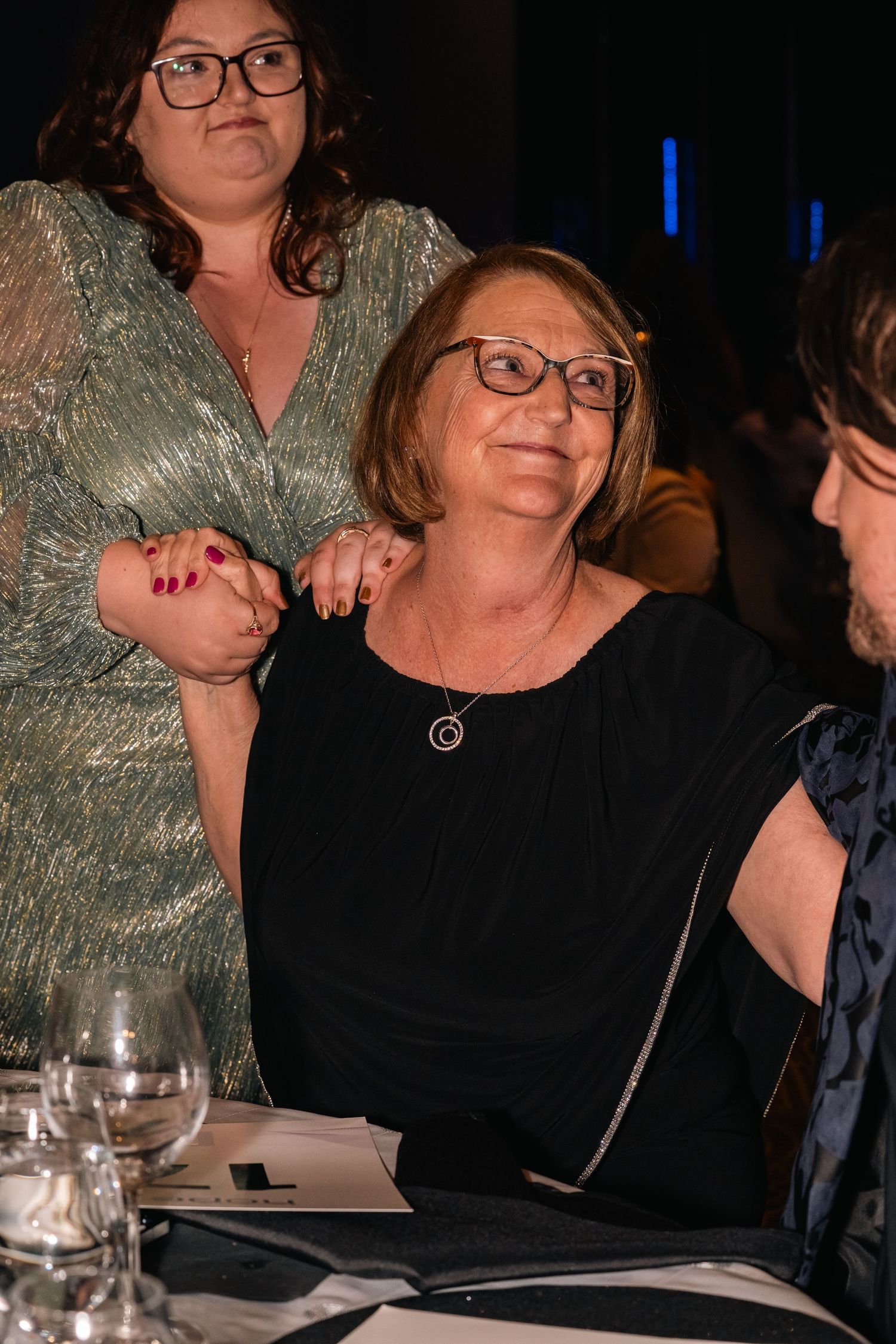 Attendees enjoying themselves at an evening gala dinner event.