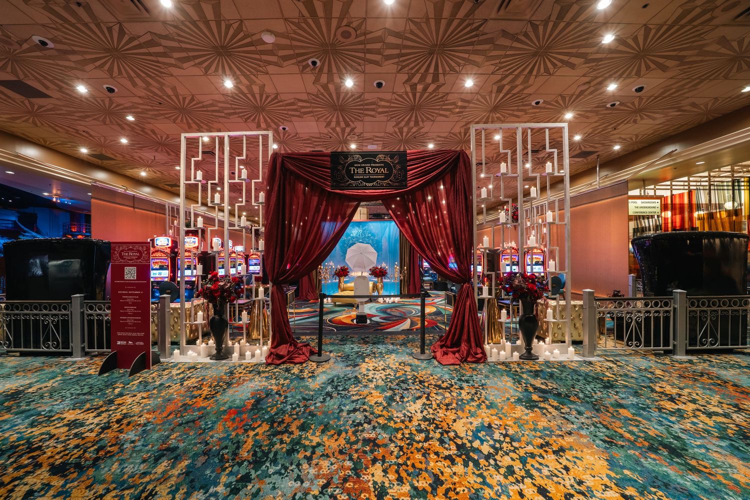 Luxurious casino entrance with red velvet curtains, ornate ceiling, and decorative lighting creating a grand atmosphere.
