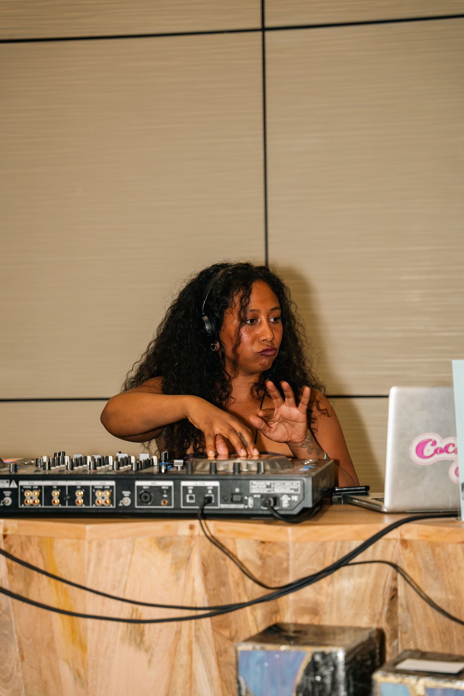 DJ performs at event using professional audio equipment and laptop.