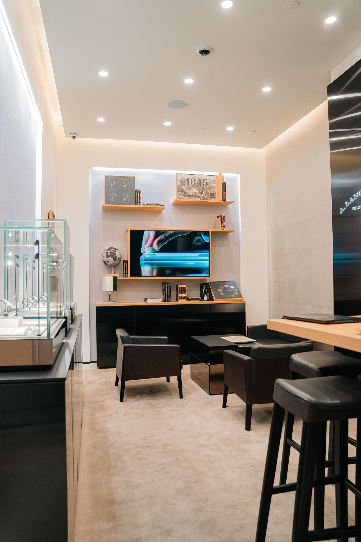 Modern lounge space with minimalist furniture, white walls, and ambient lighting.