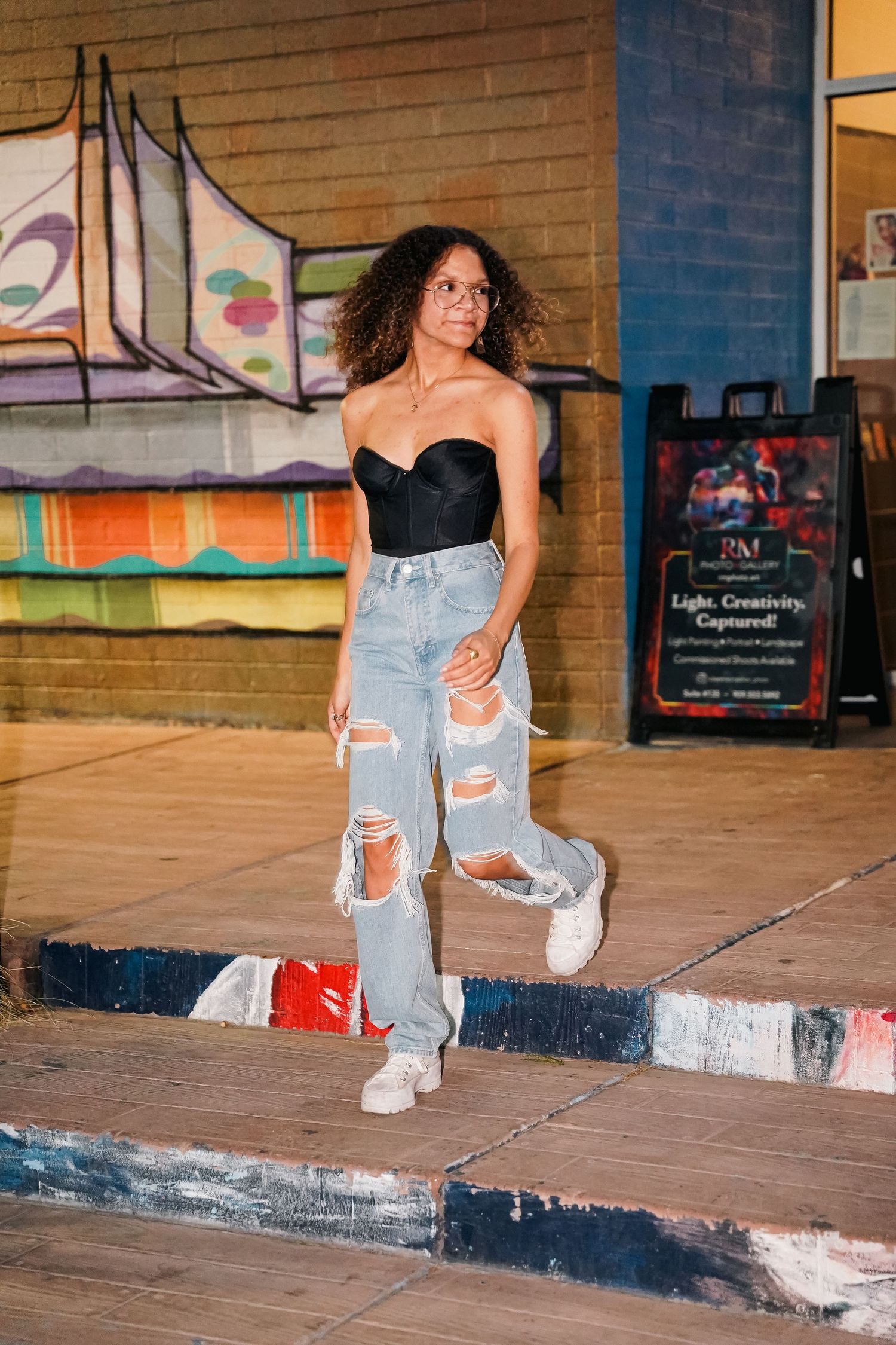 Action shots of skateboarding moves on a wooden stage with colorful graffiti walls.