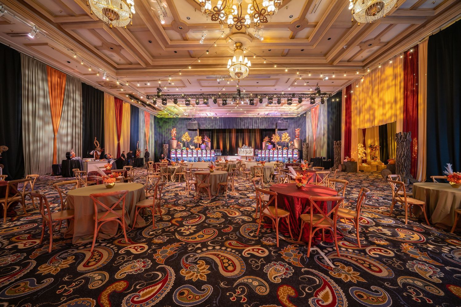 Opulent ballroom setup with crystal chandeliers and dramatic stage lighting.