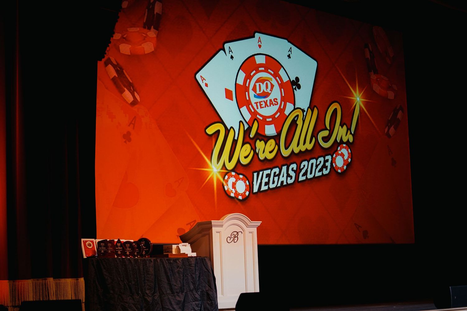 Stage backdrop displaying 'Vegas 2023' text with vibrant red and orange lighting effects.