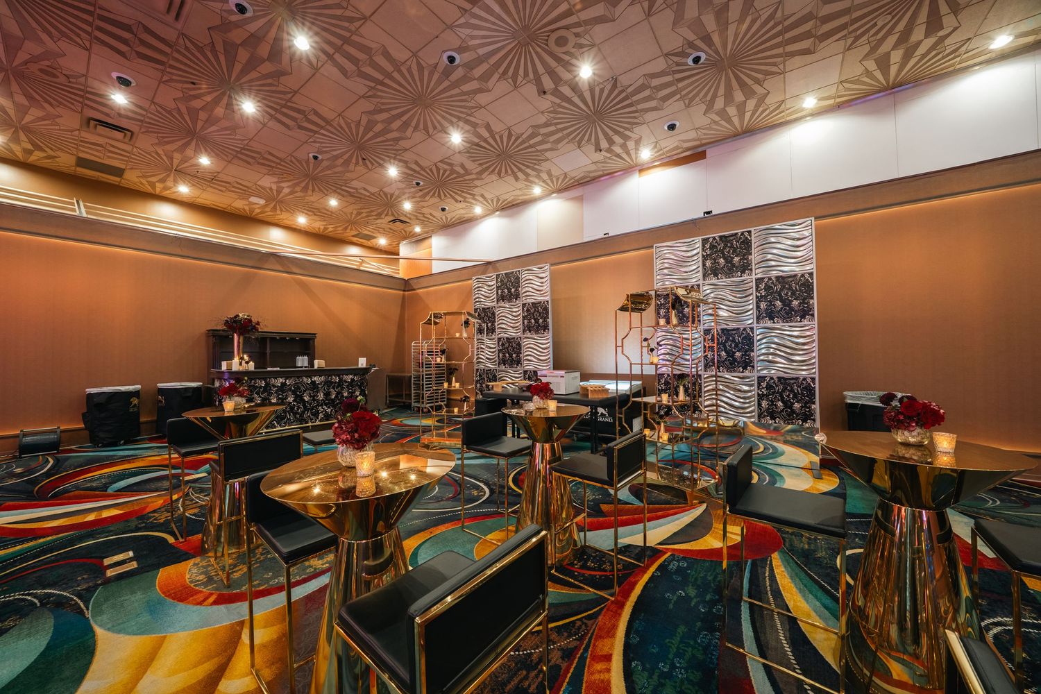Entertainment venue with stadium seating and starburst ceiling pattern.