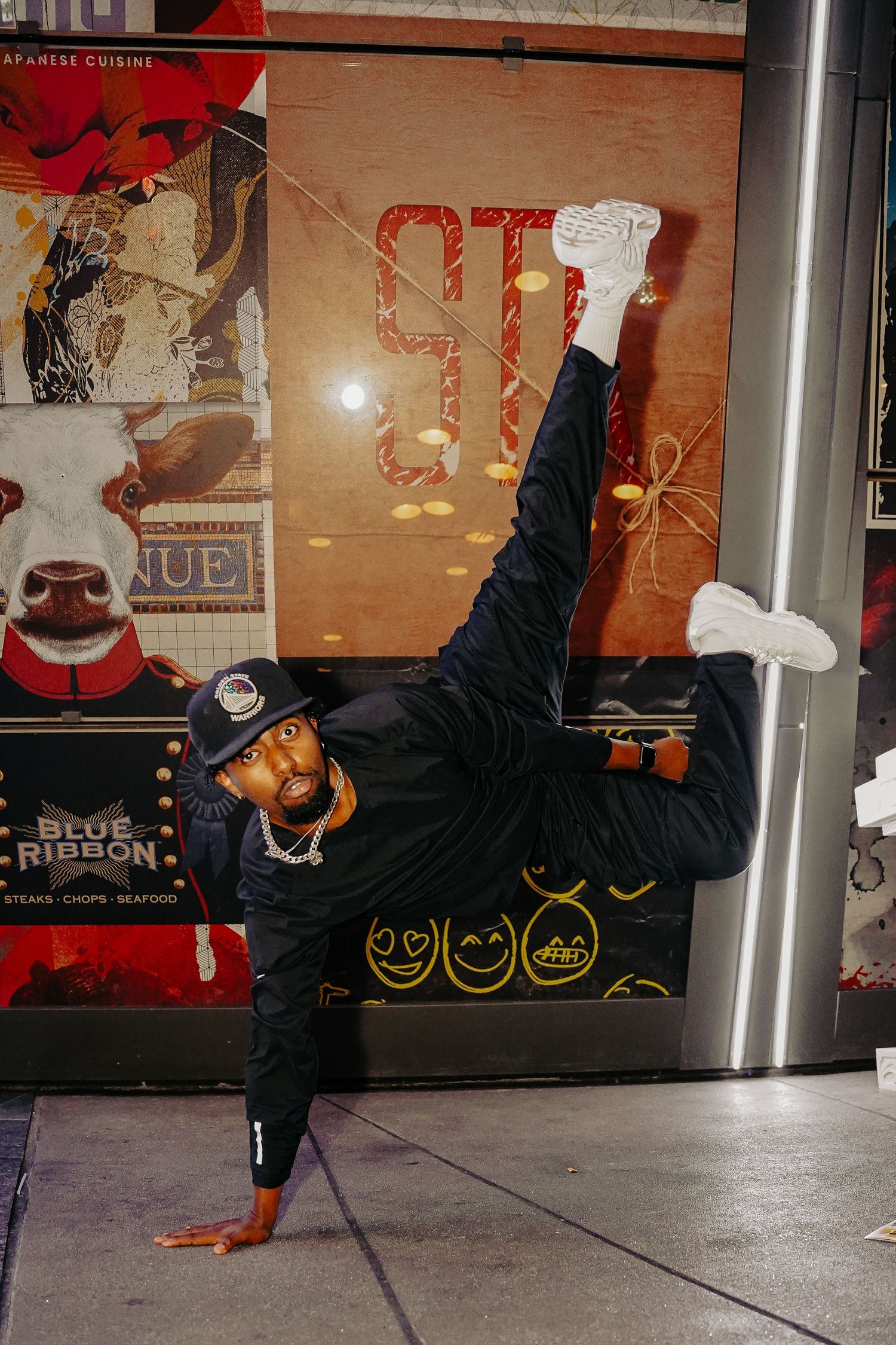 Athletic pose against graffiti wall showing impressive balancing skills.