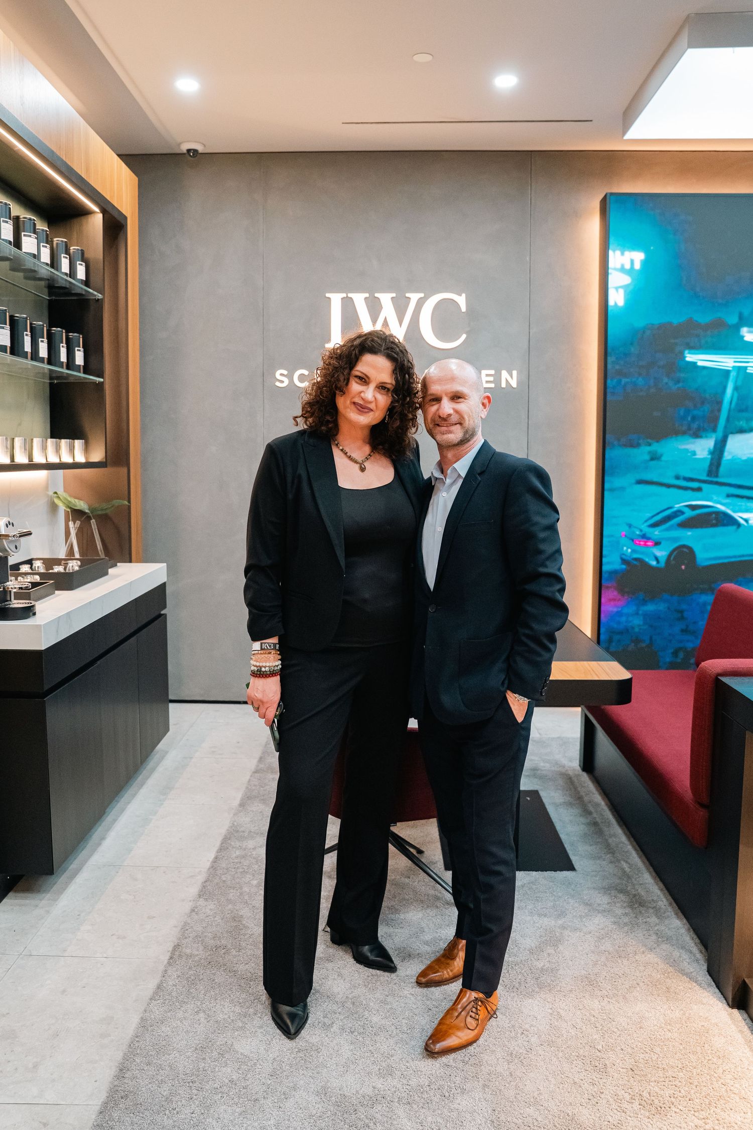 Interior of JWC luxury retail store with two people standing in formal attire.