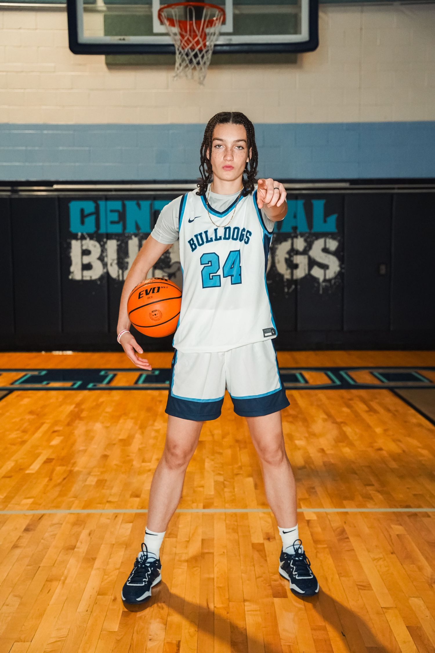 Player wearing white Bulldogs uniform number 24 stands in defensive stance on basketball court.