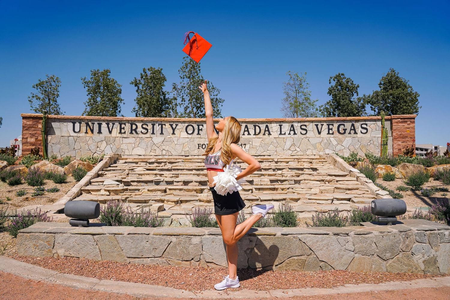 Wide panoramic view of UNLV campus entrance with stone sign.