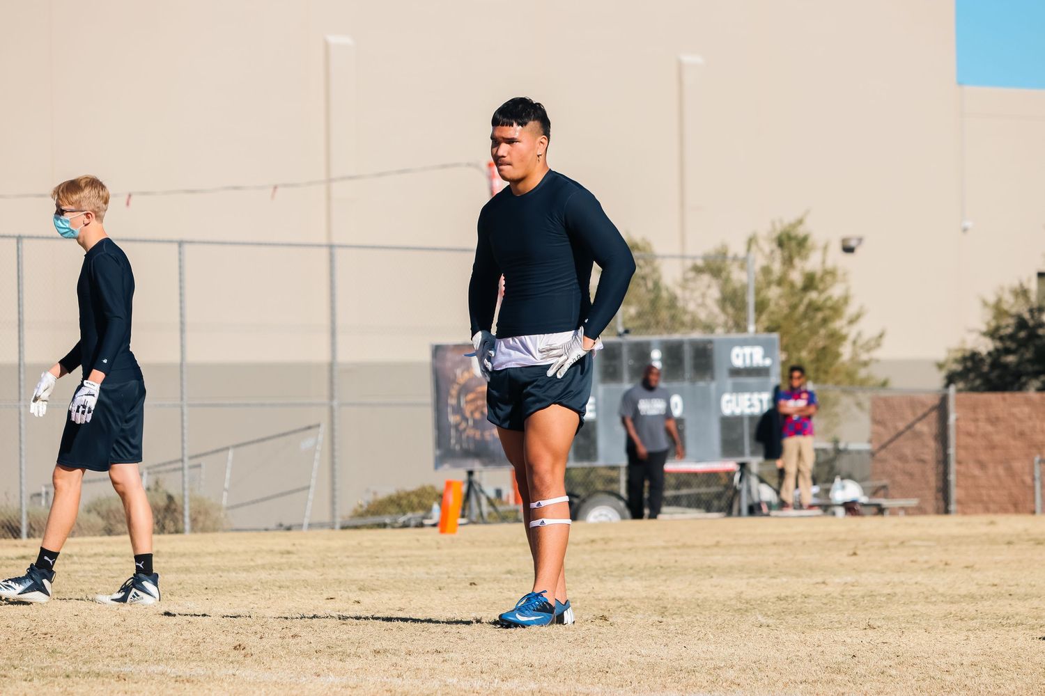 Team members practicing various drills on an outdoor sports field.