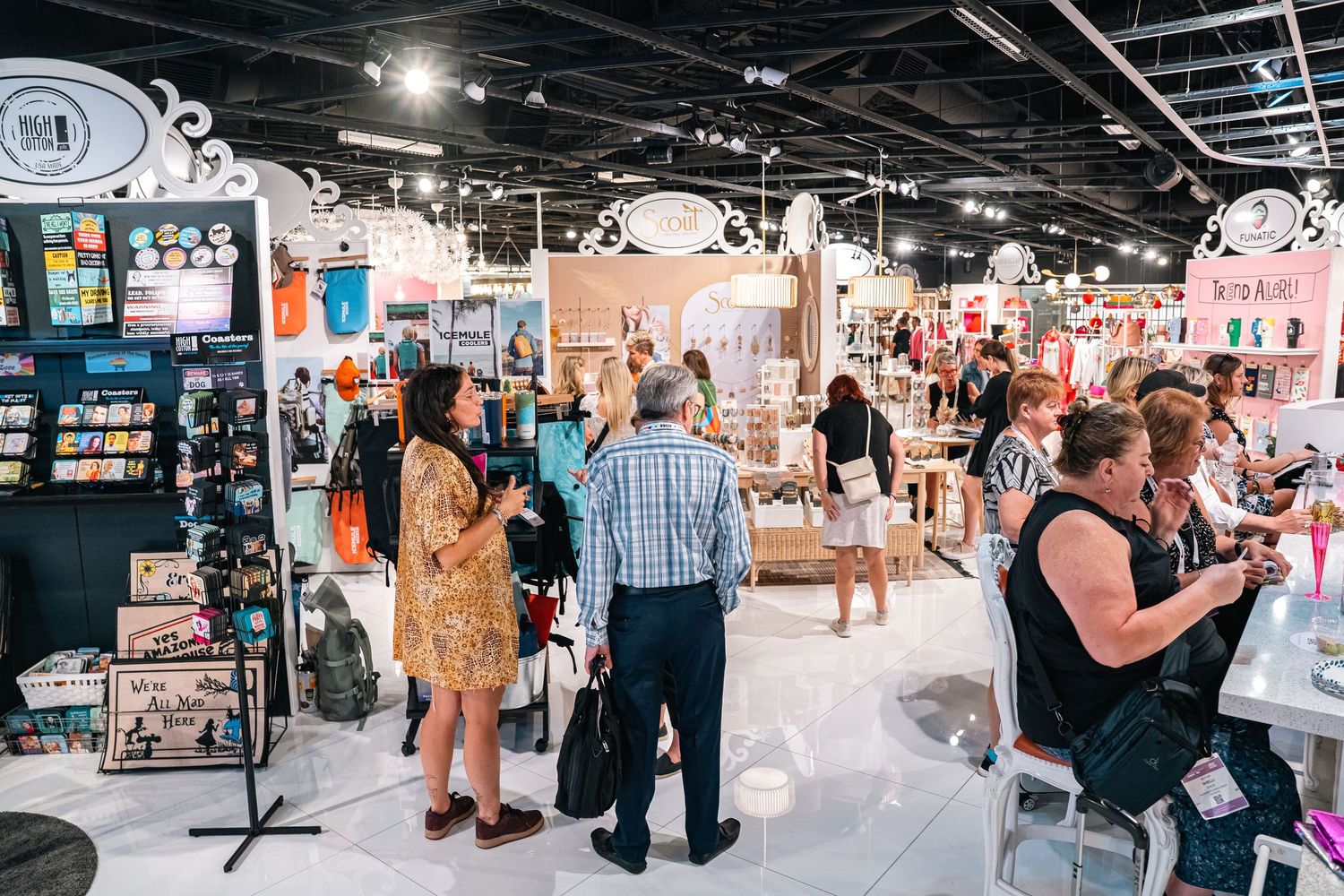 Customers browsing merchandise in modern retail store with industrial ceiling.