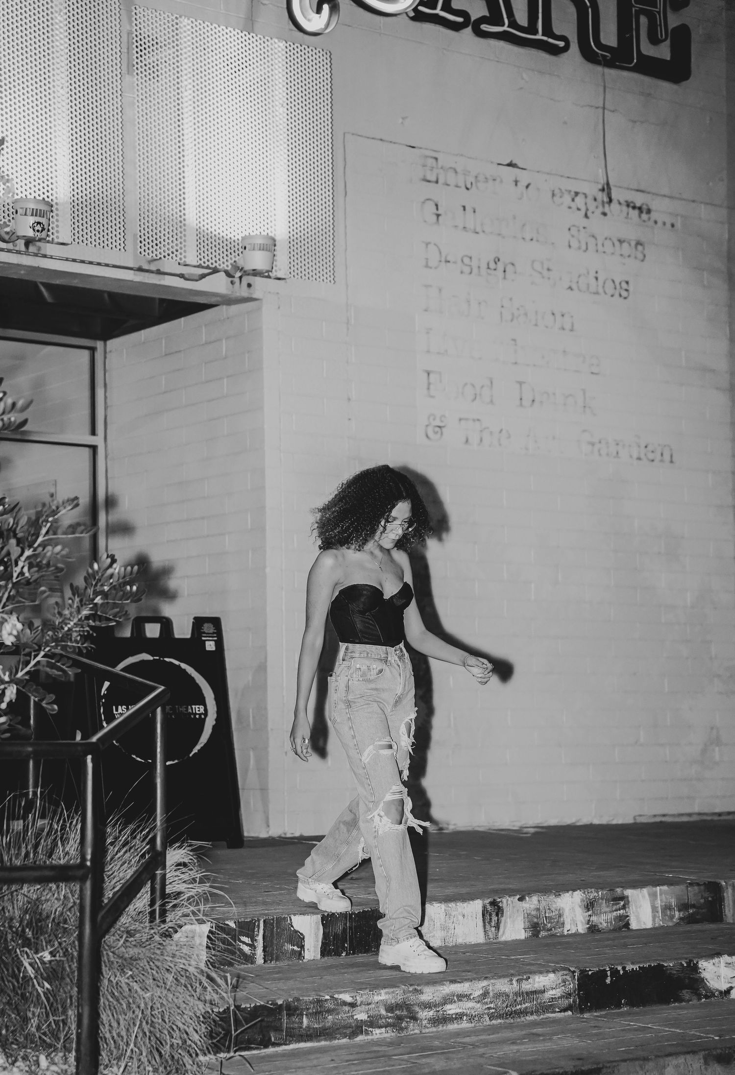A series of black and white photos showing someone skateboarding on concrete.