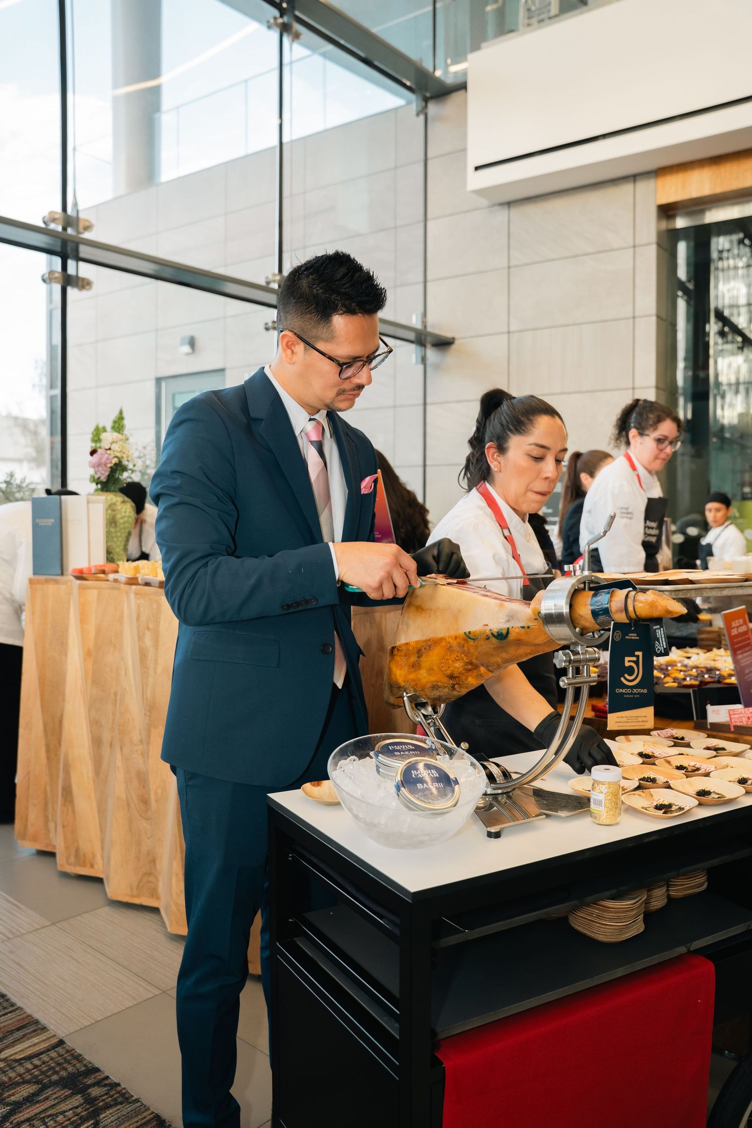 Professional bartenders preparing craft cocktails at an upscale event bar.