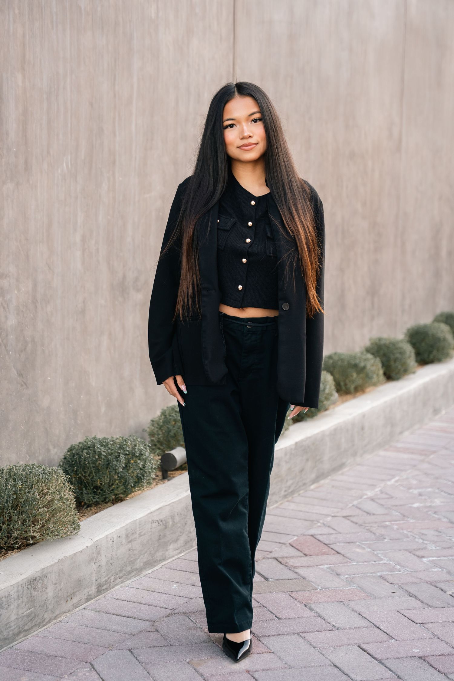 All-black ensemble featuring wide-leg pants and cropped button-up top.