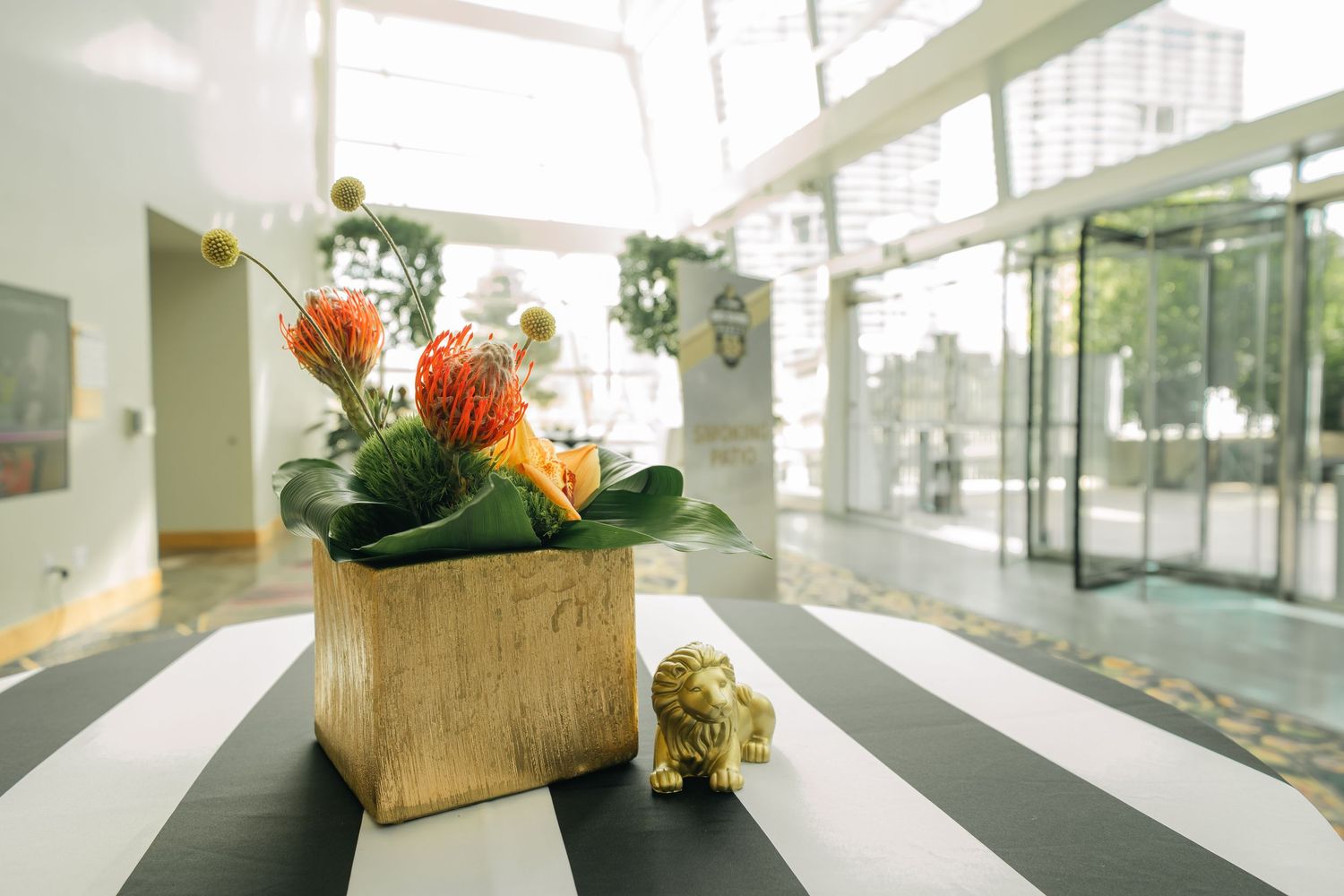 Modern office corridor with bright lighting and decorative wooden crates with flowers.