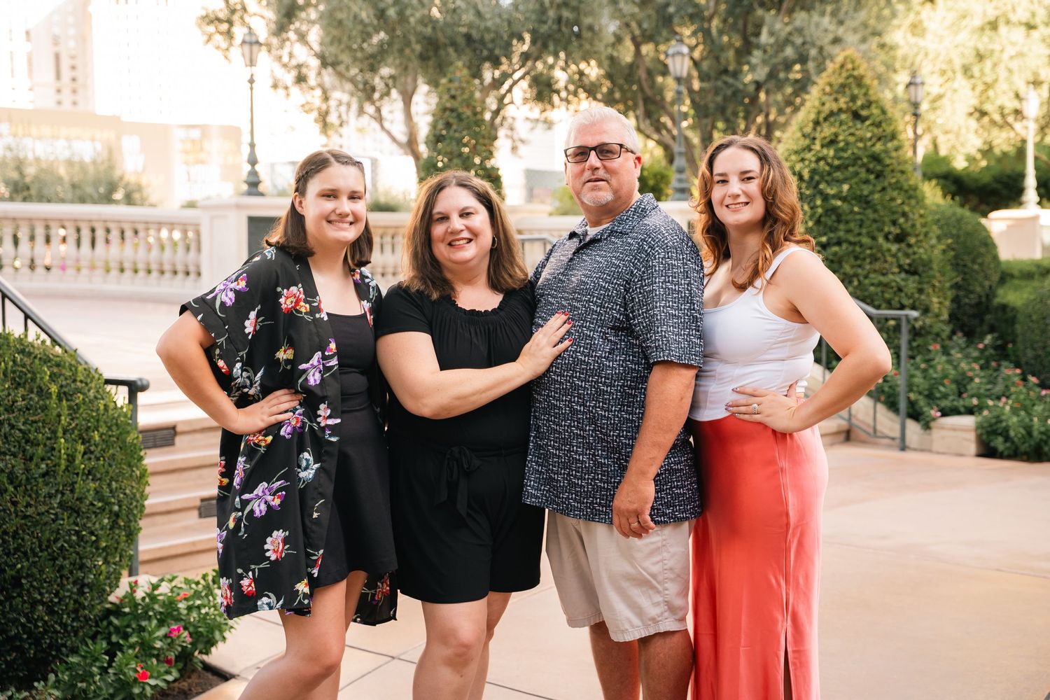 Group photo of family members posing together on a terrace with landscaped gardens.