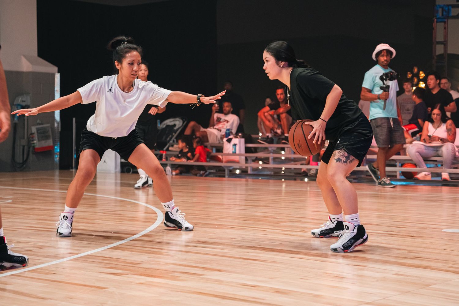Players practicing basketball moves and drills on a wooden gymnasium floor.