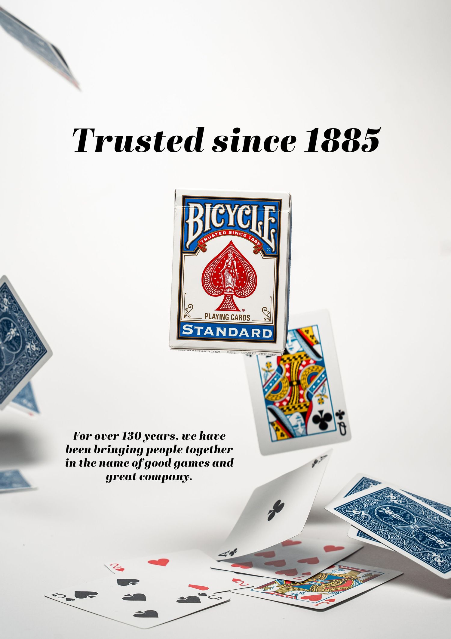 Bicycle playing cards brand photography showing scattered cards and vintage logo.