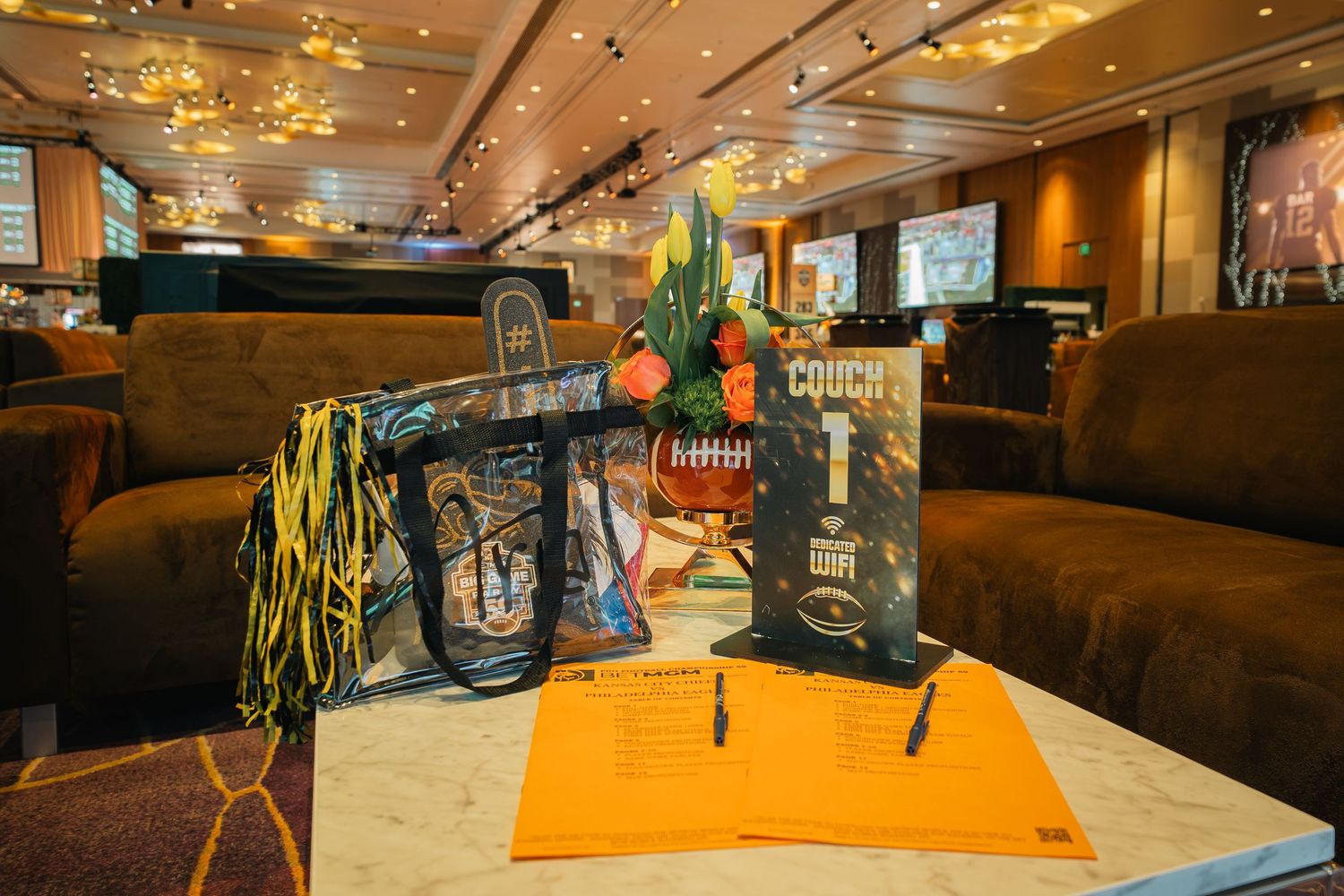 Casino lounge space with comfortable seating and contemporary orange decor elements.