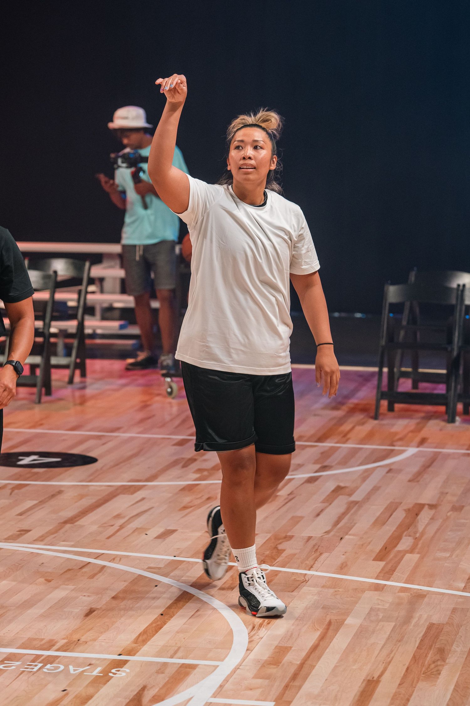 Athletes performing drills and exercises on a polished basketball court.