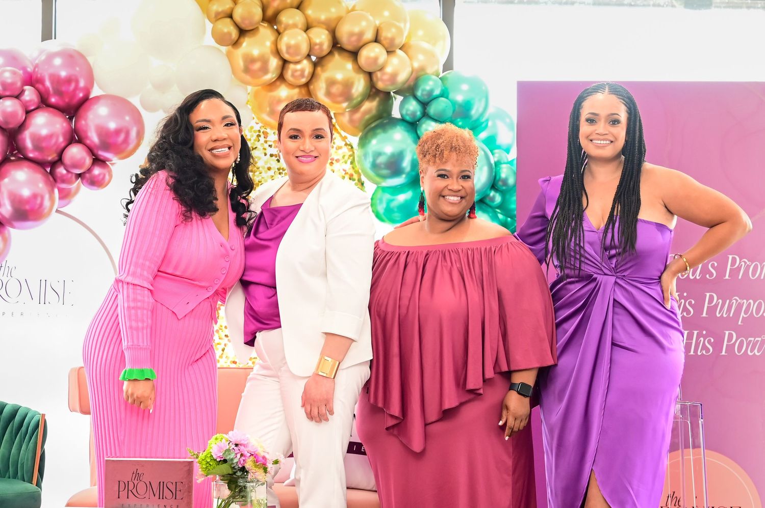 Group photo at elegant party with balloon decor in pink, gold and teal colors.