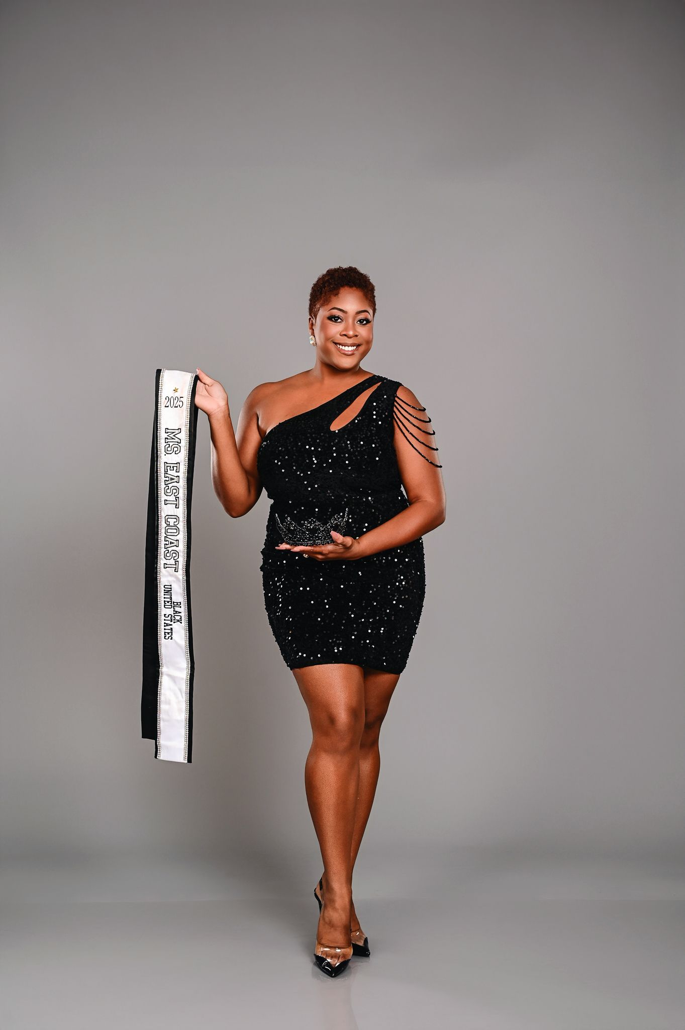A person in a sparkling black mini dress poses confidently against a gray studio backdrop in a series of dynamic shots.