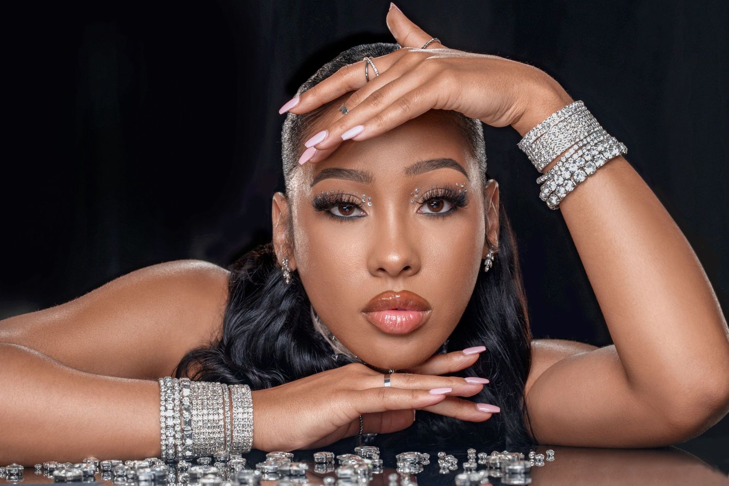 Luxury beauty portrait with crystal bracelets and glamorous makeup.
