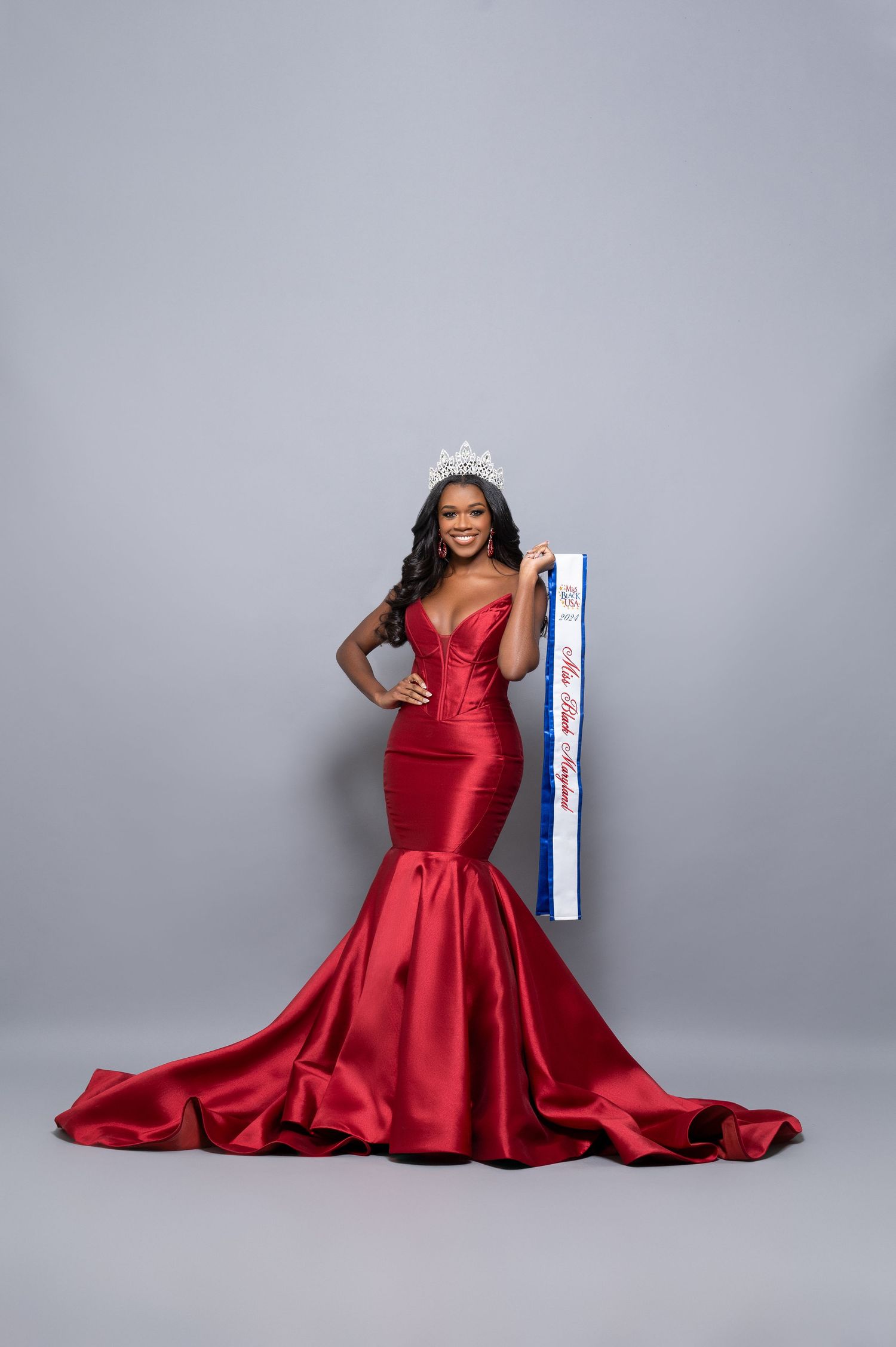 A stunning red satin ball gown with a sweetheart neckline and dramatic train shown in multiple glamorous poses.