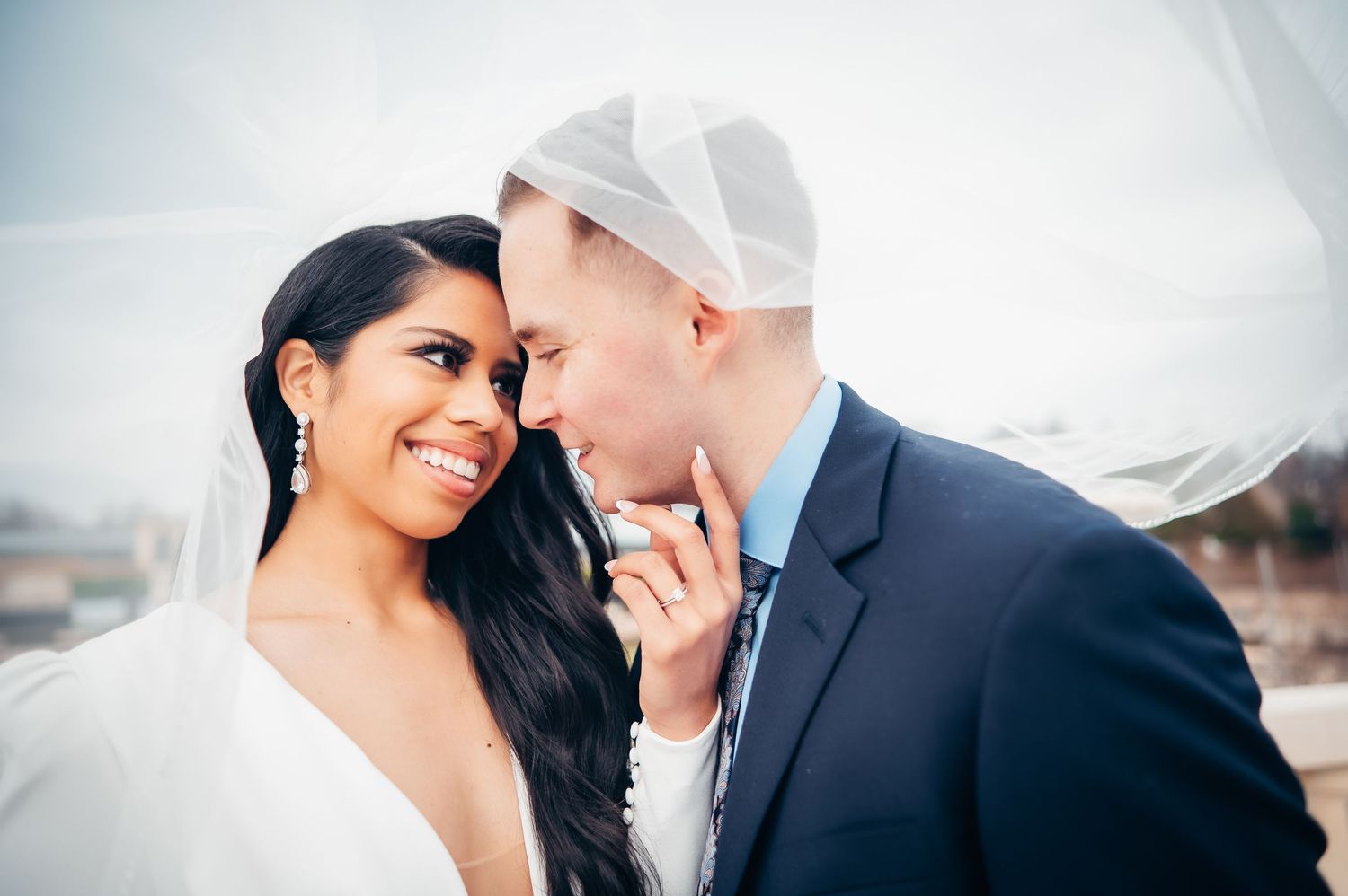 A couple shares an intimate moment together during their winter wedding photoshoot.