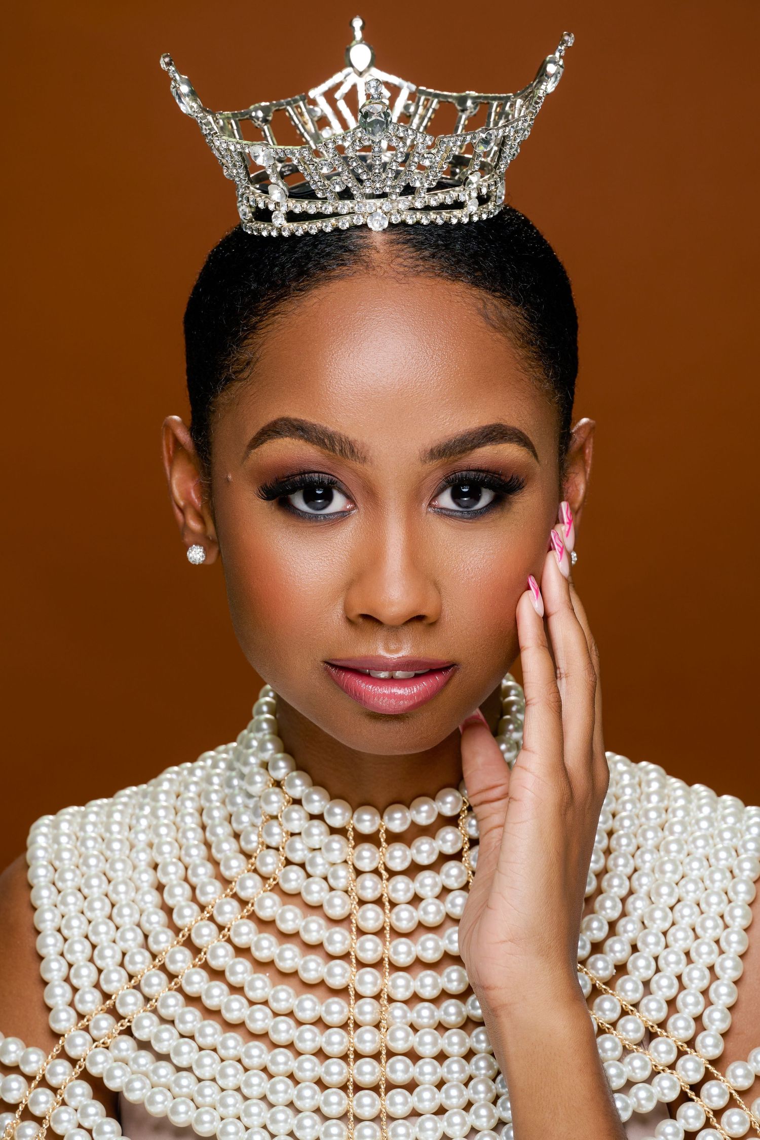 Elegant portrait series featuring pearl necklaces, a sparkling crown, and glamorous evening makeup against a brown backdrop.