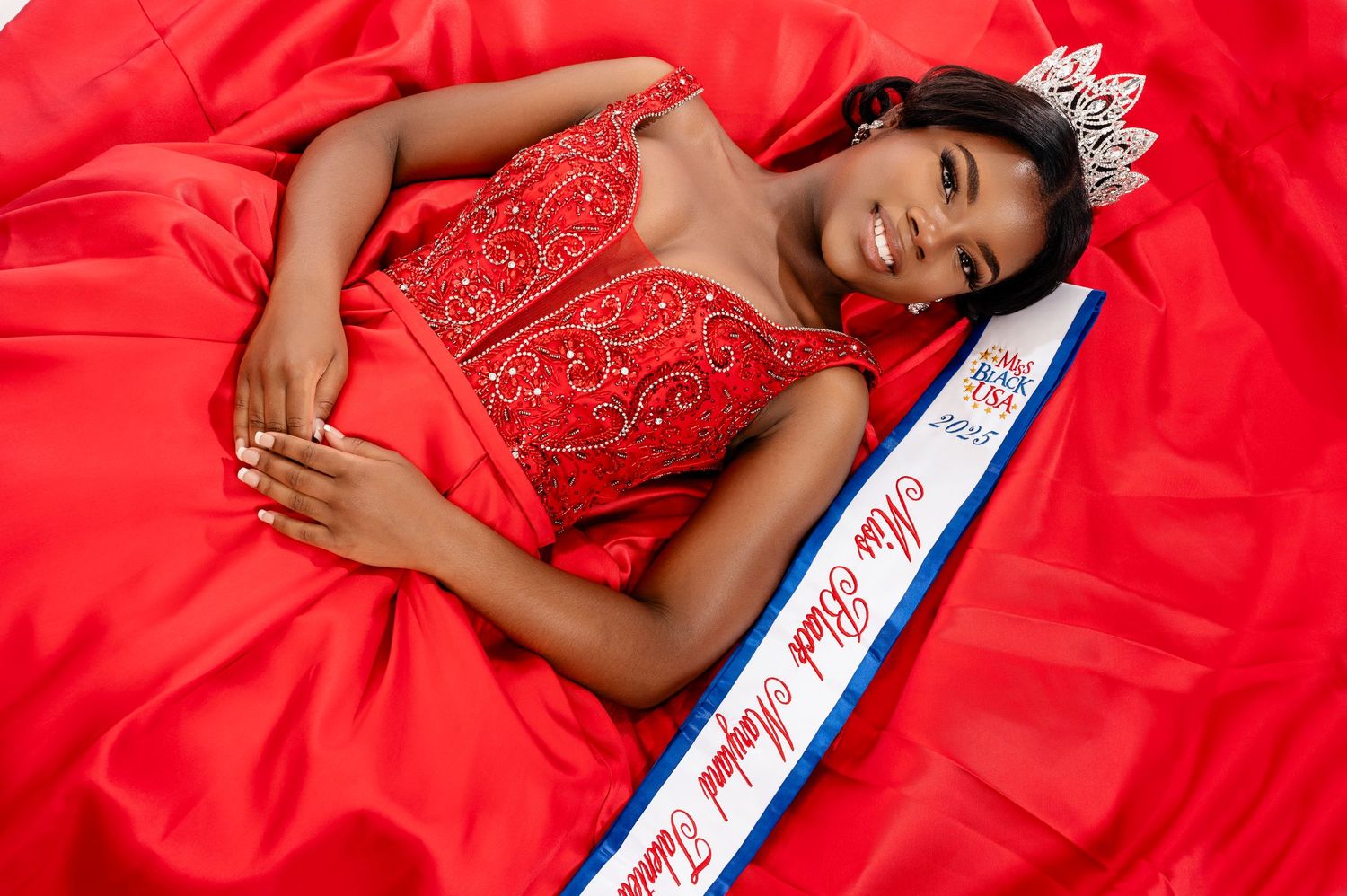 A person wearing a red dress lies on a sash with text while posing in multiple similar shots.