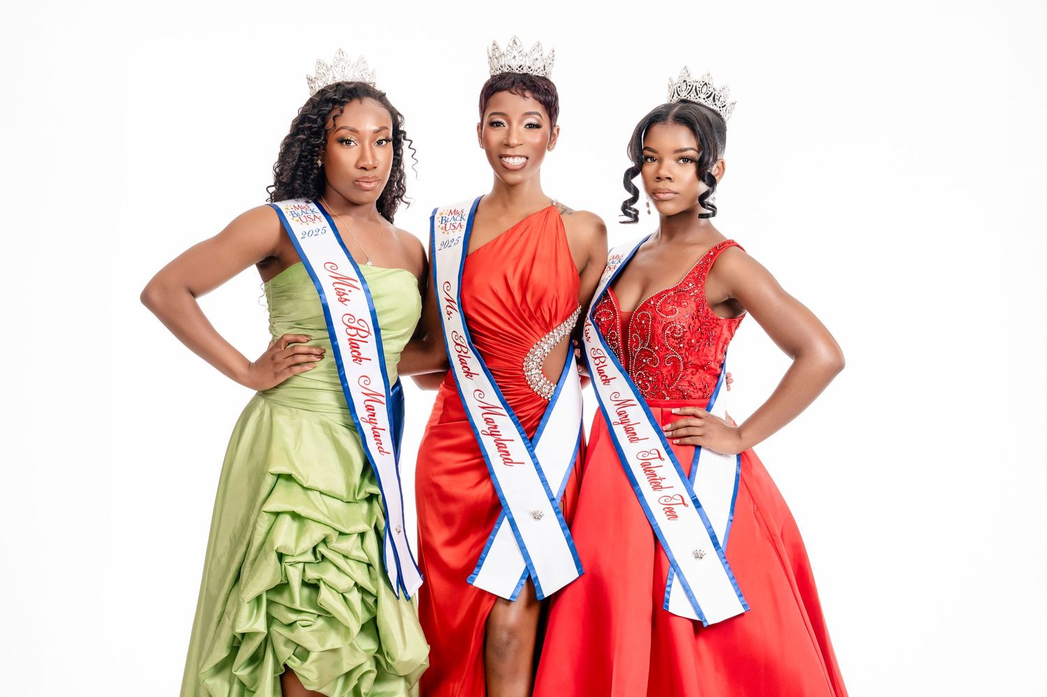 Three pageant contestants wearing elegant gowns in green and red posing together with crowns and sashes.