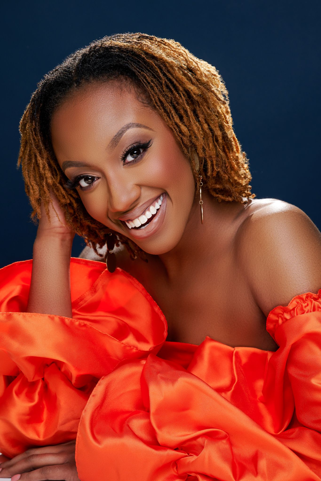 A glamour portrait series shows a woman in a bright red ruffled dress against a dark blue background.