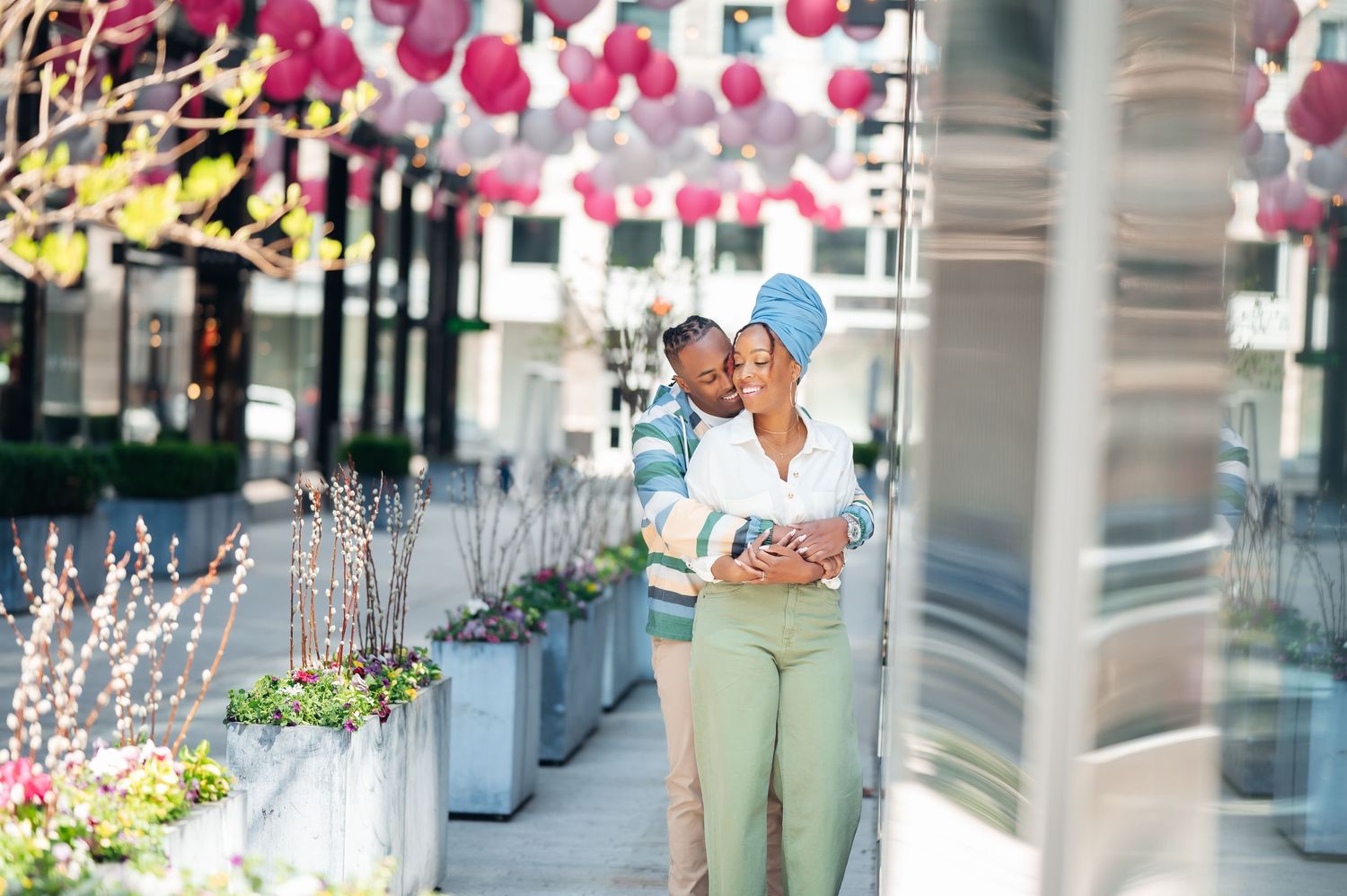 Outdoor restaurant patio decorated with pink and yellow paper lanterns and string lights in an elegant setting.
