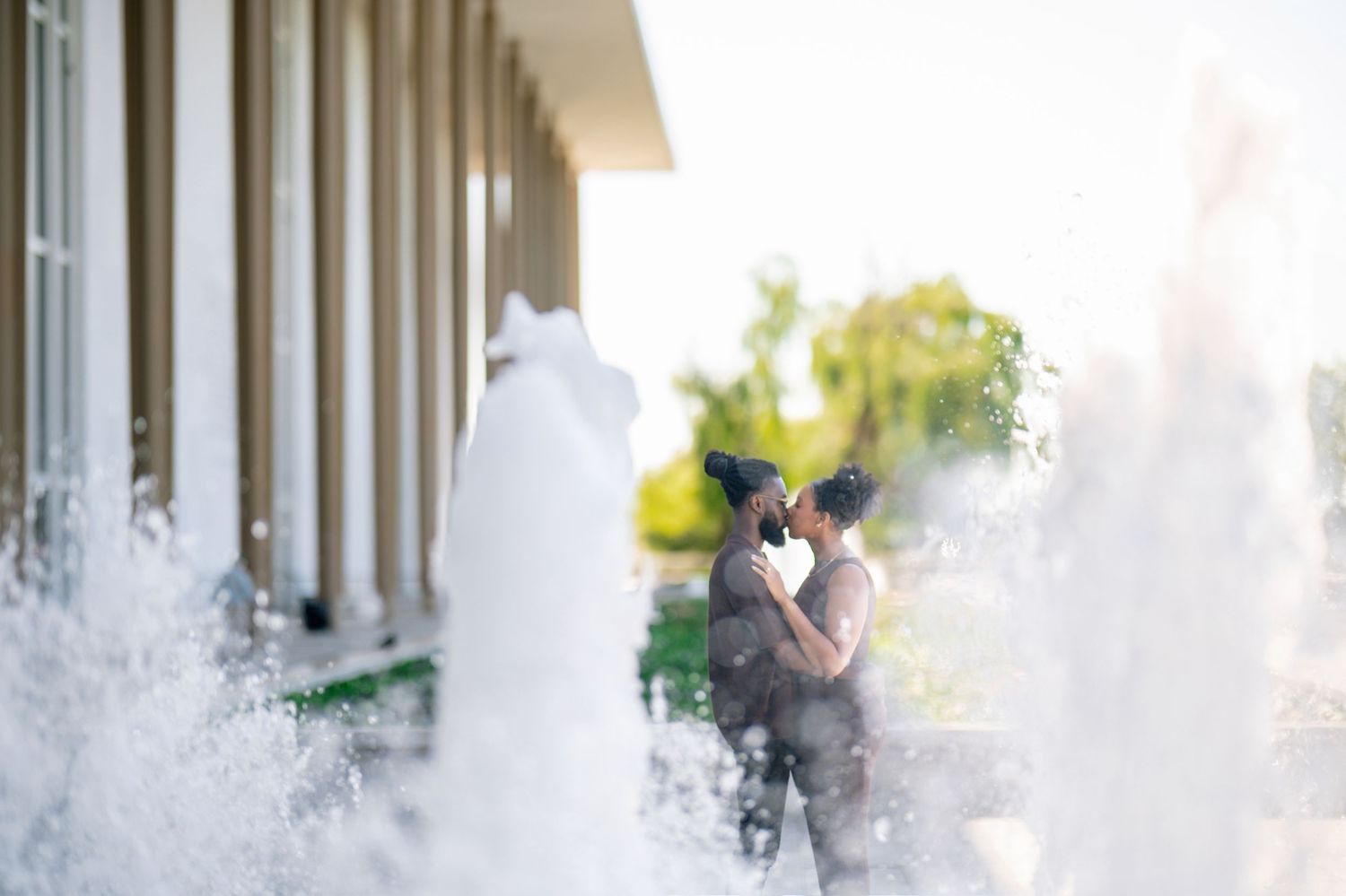 A dramatic sequence of water splashing and spraying in a row against a light colored background.