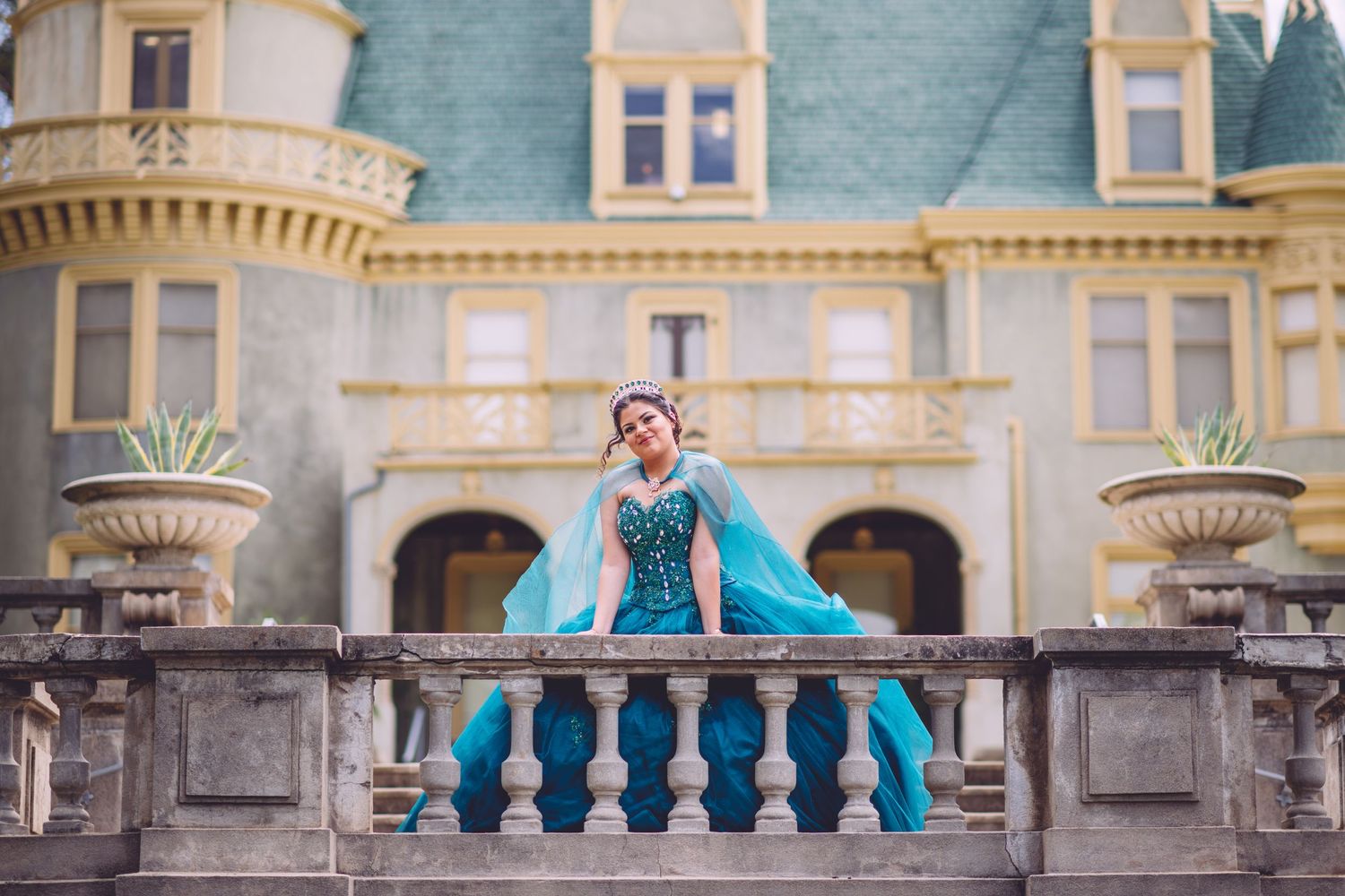 Stunning aqua blue gown contrasts beautifully against ornate Victorian architecture.