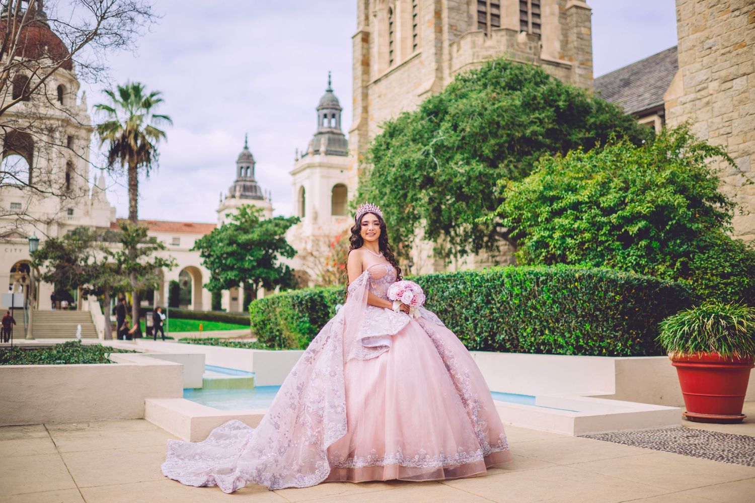 Blush pink princess ball gown photographed at historic Spanish-style architecture.