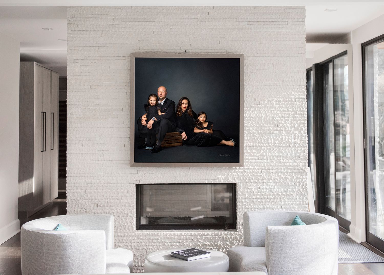 Modern white living room with white brick wall featuring a framed family portrait above a sleek fireplace.