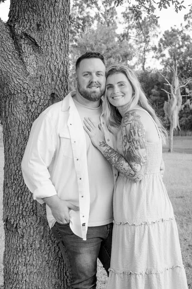 randy wouters and amy wouters pose by tree